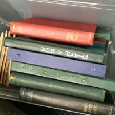 A box containing several albums of mixed world stamps.