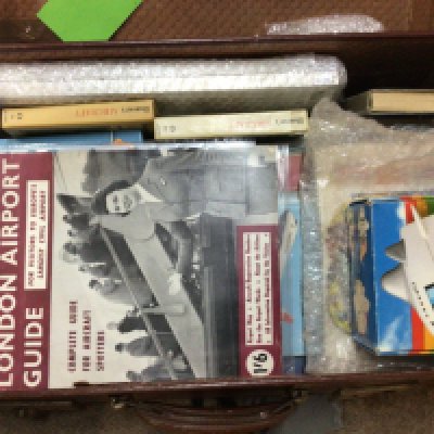 A vintage suite case containing Aircraft memorabilia including early promotional civil aviation brochures coin collection and other related ephemera.