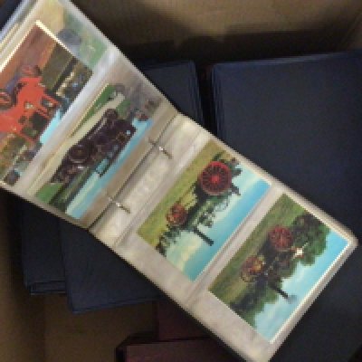 A box containing a collection of albums of postcards and cigarette cards.