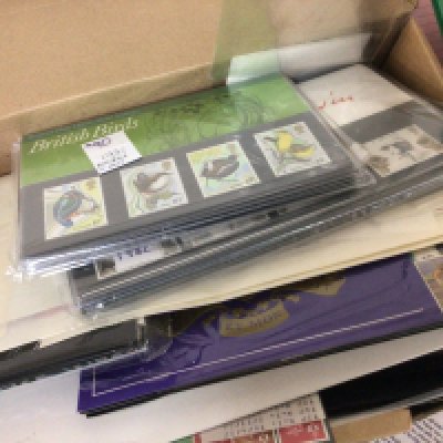 A box containing presentation stamp packs mixed Elizabeth II and pictorials and an album of interesting world first day covers early examples and other first day covers.